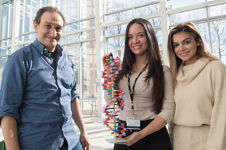 Bioengineering students Luz Vargas Restrepo and Meena Alzamani pose with Juan Cebral, bioengineering professor.