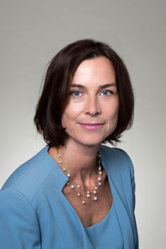 Bioengineering staff member Claudia Borke has short, brown hair and wears a teal blouse with pearls in her profile
